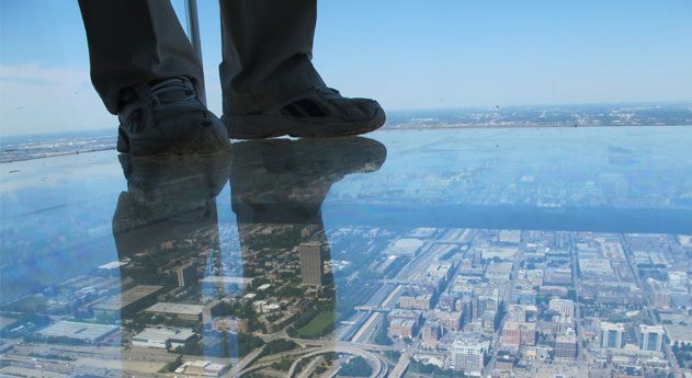 Man standing on a transparent glass floor